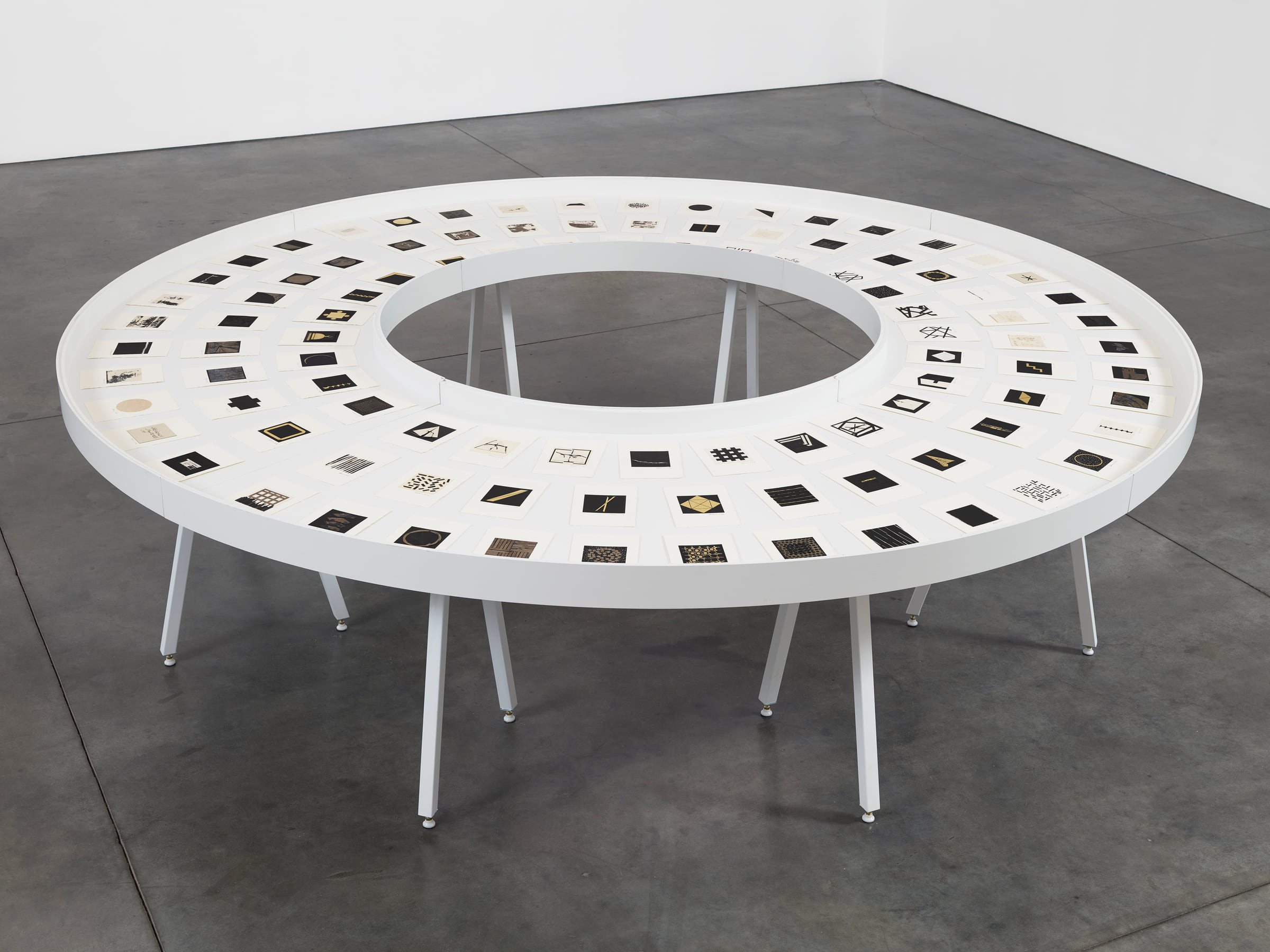 Zarina’s The Ten Thousand Things III, one hundred miniature collages arranged in a circular vitrine