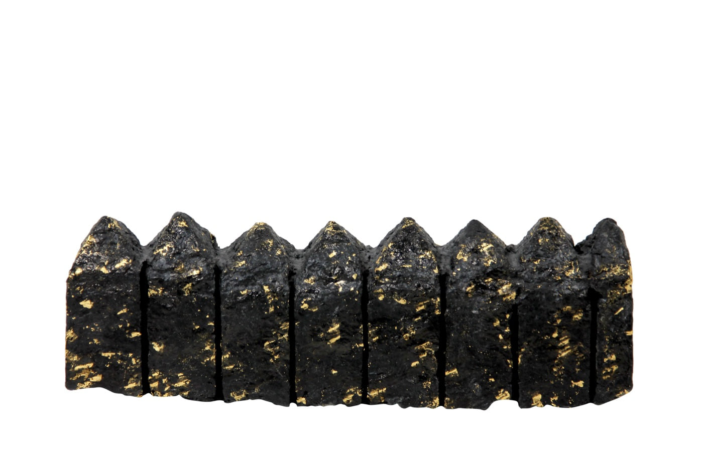 Houses, 1982, eight dark and gold cast-paper dwellings arranged in a measured horizontal sequence