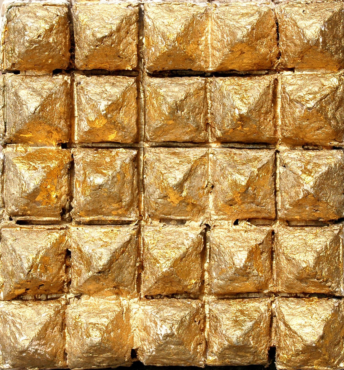 Roofs, 1982, a gold-leafed cast-paper relief built from a dense grid of raised roof-like forms