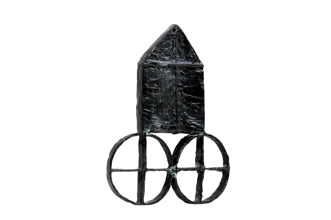 A dark metal house mounted on open wheels from Zarina’s House on Wheels series