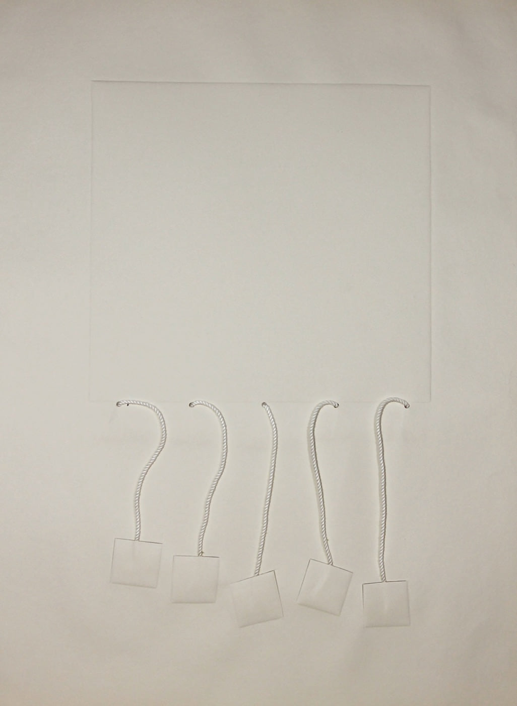 Untitled, 1974, a nearly white embossed sheet with five lengths of silk cord and small suspended squares